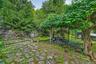 Stone paver patio with natural rock retaining wall