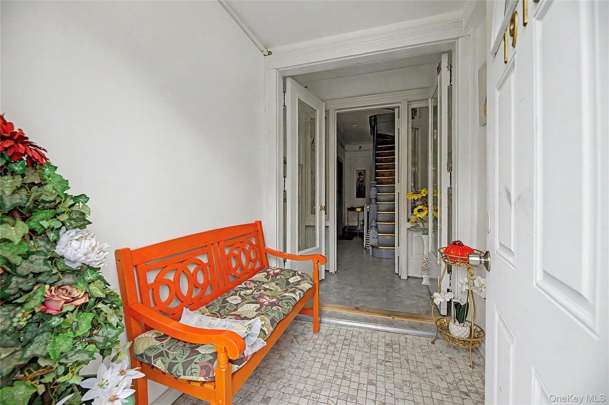 Welcoming covered foyer aka mudroom, leading into the home.