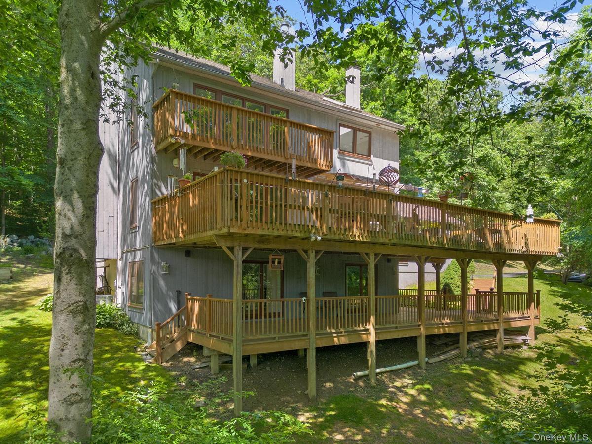 Step outside to the expansive decks, offering an idyllic setting for outdoor dining, entertaining, or simply relaxing while taking in the beauty of th