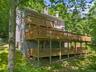 Step outside to the expansive decks, offering an idyllic setting for outdoor dining, entertaining, or simply relaxing while taking in the beauty of th