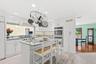 At the heart of the home, the beautifully appointed custom chef’s kitchen combines sophisticated style with exceptional functionality, creating an inv