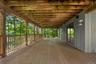 The expansive lower-level deck creates a welcoming outdoor retreat—perfect for enjoying a good book, sipping a cup of tea, or simply relaxing amid the