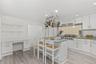 The thoughtfully designed kitchen is complete with a built-in desk to keep daily life organized and a spacious center island, perfect for enjoying mor
