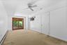 The lower level also offers a private bedroom with direct deck access, where expansive mahogany-trimmed glass doors invite abundant natural light whil