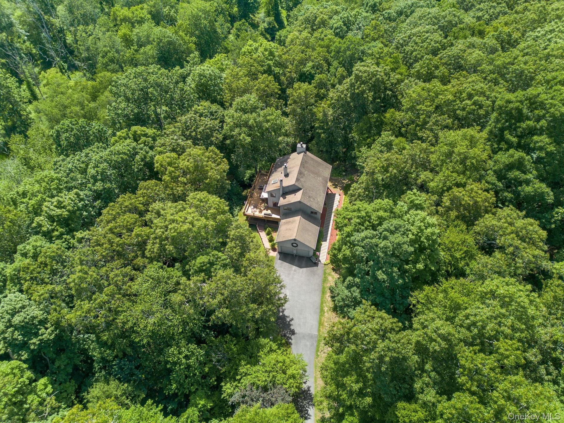 Custom-built contemporary home offering exceptional privacy, surrounded by lush greenery and tranquil landscaping that creates a peaceful, secluded ha