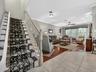 View from the entry foyer thru to the living room and stairs leading to bedroom level.