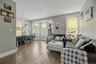 Hardwood flooring throughout, multiple windows, and crown molding