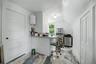 White walls with a window, stainless steel refrigerator, and stainless steel range