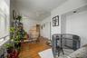 Hardwood flooring throughout, multiple windows, and crown molding