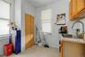 White walls with a window, stainless steel refrigerator, and stainless steel range