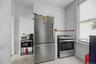 White walls with a window, stainless steel refrigerator, and stainless steel range