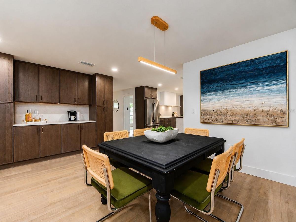 PERFECT DINING SPACE WITH COFFEE BAR/SERVING AREA, CABINETRY AND 2 PANTRIES