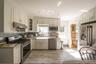 New kitchen layout with timeless finishes makes this a bright kitchen that catches the afternoon light over the kitchen sink.