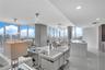 Open living and kitchen great room framed by floor-to-ceiling glass