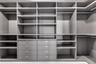Oversized walk-in closet with fully built-out cabinetry