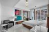 Primary suite with sitting area, art wall, and Biscayne Bay views