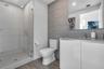 Guest bath with walk-in glass shower and floating vanity