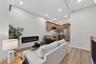Open-concept living area featuring an electric fireplace, wood-finish flooring, recessed lighting, and a kitchen with wood cabinetry and stainless ste