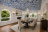 Elegant dining room with an ornamental plasterwork ceiling with another cozy fire place
