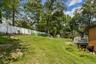 Rear of property showing fence, deck, and lots of room