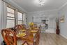Contemporary light fixtures, crown moldings, kitchen pass-through, and neutral wall tones.