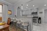 Kitchen featuring light gray cabinetry, stainless steel appliances, recessed lighting, and a breakfast bar.