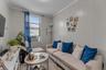 Bright, light-filled living room featuring white shiplap walls and large multi-pane windows.