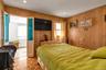 Parquet wood-finish flooring, wood paneling, recessed lighting, double doors with textured glass, and a window unit