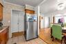 Kitchen featuring light wood cabinetry, tiled flooring, and a stainless steel refrigerator