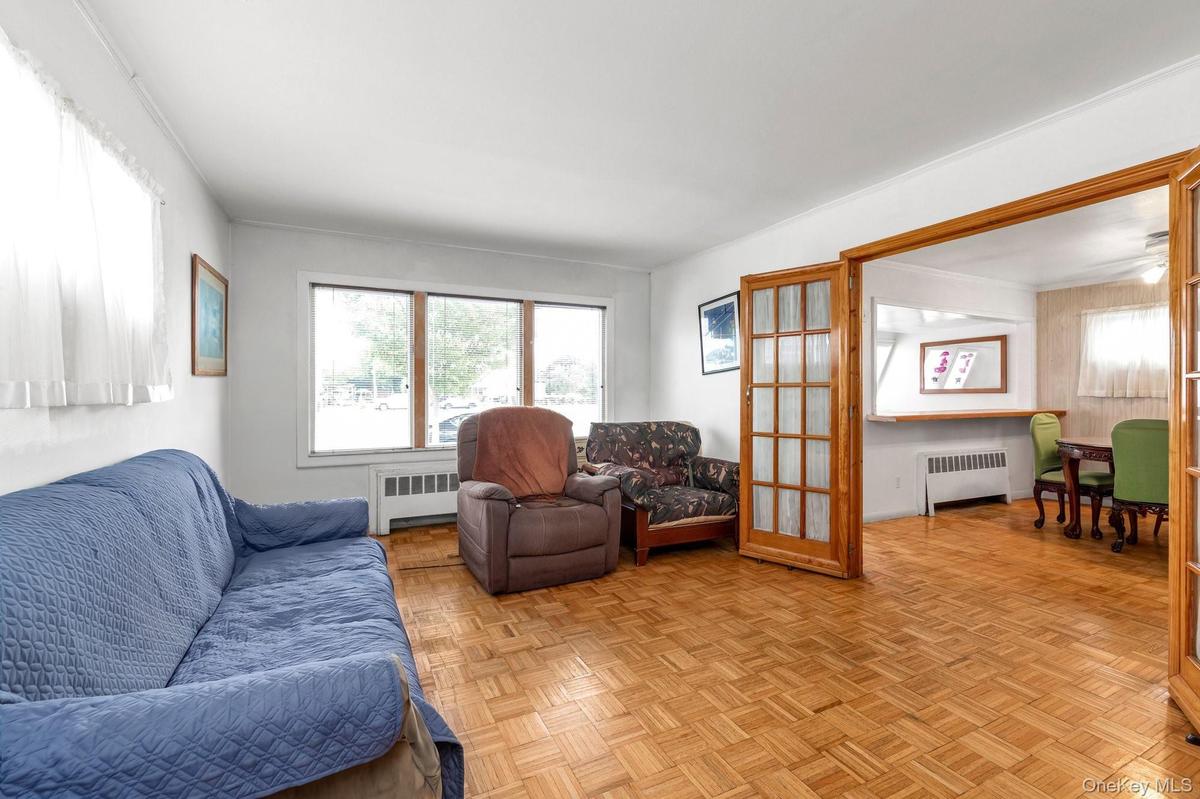 Parquet wood-finish flooring, white walls, and wood-frame doors with glass panels