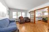 Parquet wood-finish flooring, white walls, and wood-frame doors with glass panels