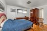 Parquet wood flooring, a ceiling-mounted light fixture, and a window air conditioning unit