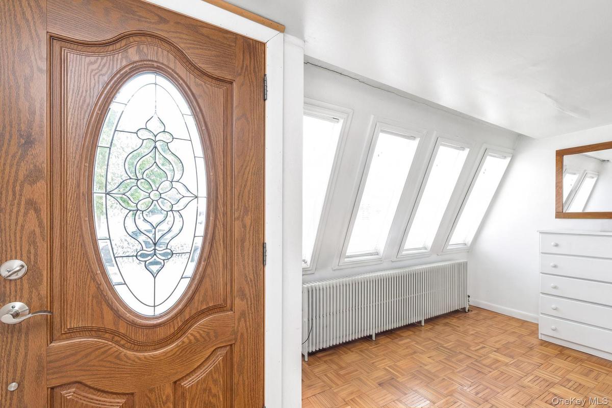 Wood-paneled entry door with decorative glass insert