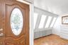 Wood-paneled entry door with decorative glass insert