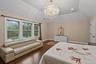 Bedroom featuring a chandelier, dark wood-type flooring, lofted ceiling, and recessed lighting