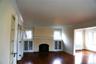 Living room featuring wooden floors a fireplace and to the right of the photo it flows right into the library slash den slash office