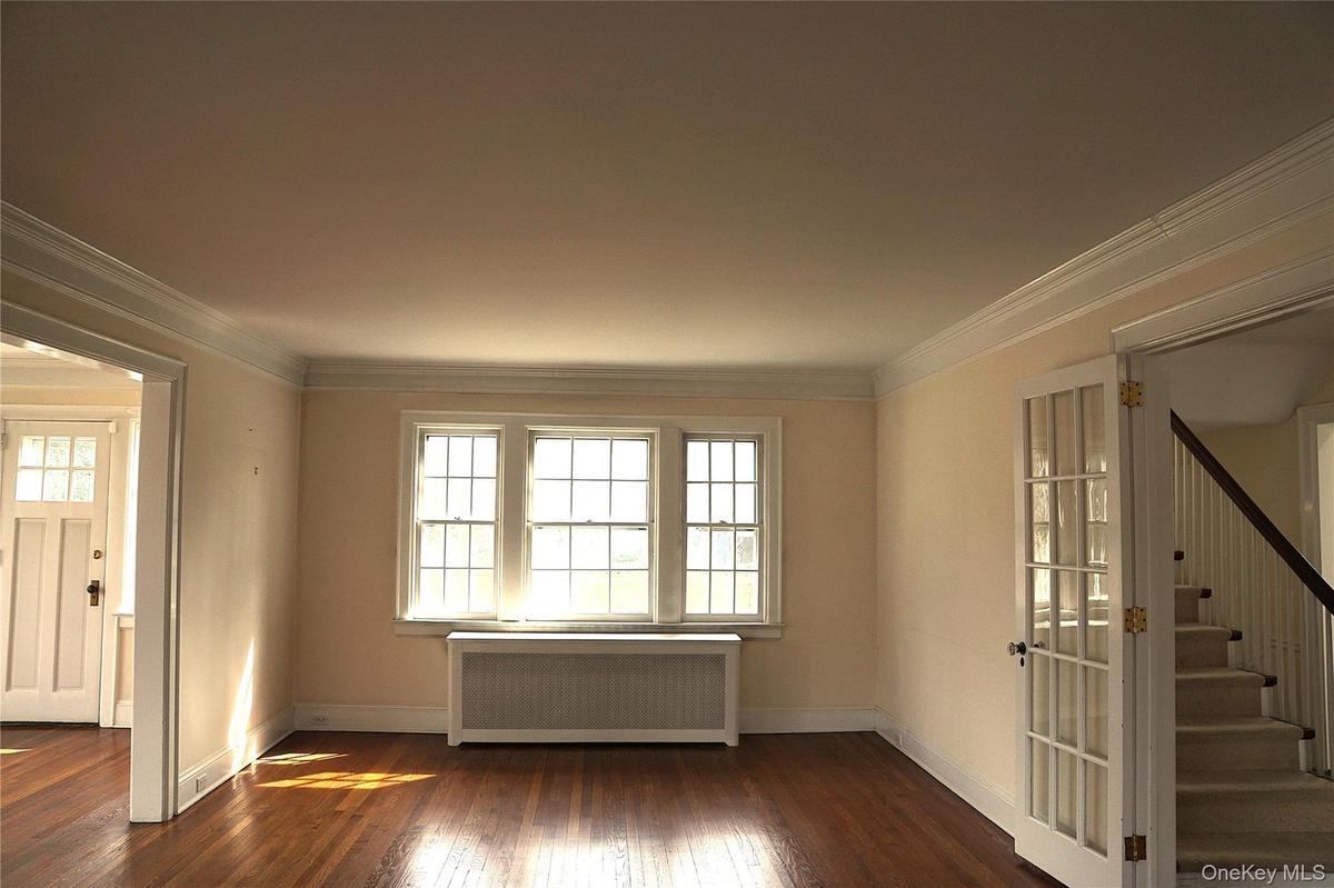 Another angle of the living room showing the steps going to the second floor on the right in the exit from the we described in the photo before