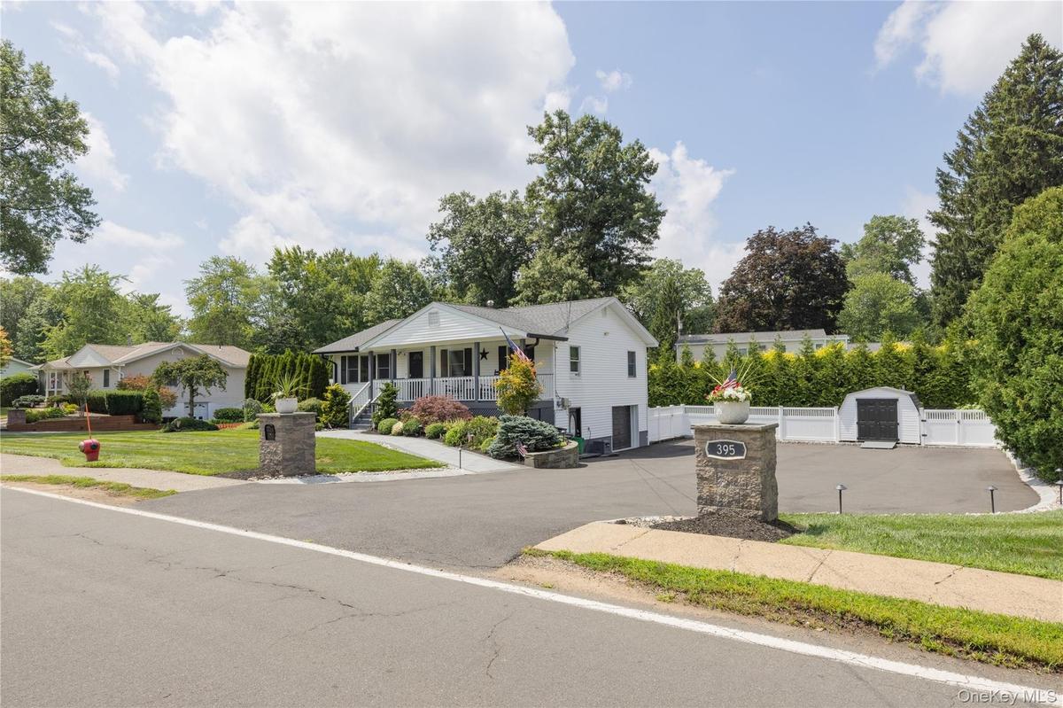 White siding exterior with a covered front porch and column accents