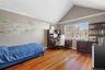 Upper Bedrm, vaulted ceiling with white crown molding, wood-finish flooring, and a large window