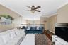 Recessed lighting, crown molding, ceiling fan, wood-finish flooring, and a second-story railing