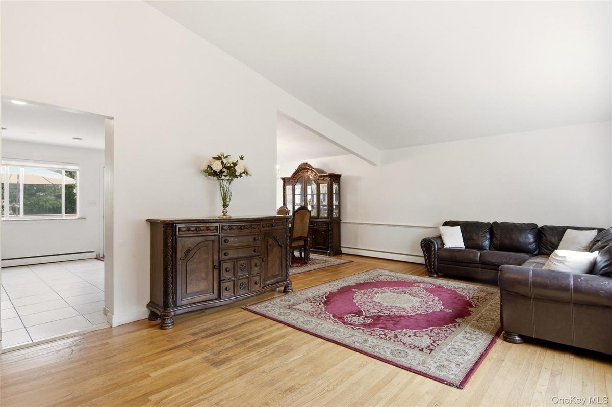 Hardwood-finish flooring, white walls, and bright white trim