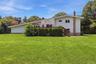 Expansive grounds with mature landscaping and lush lawn