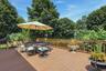 Expansive outdoor deck with a brown wood-finish surface, complete with a surrounding railing