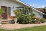 Brick paver walkway with a brick step entry, white siding exterior, and an attached two-car garage