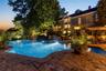 Twilight at 6 Canterbury Ct. in the resort-like property including pool with infinity edge, spa, patio, outdoor kitchen and firepit.