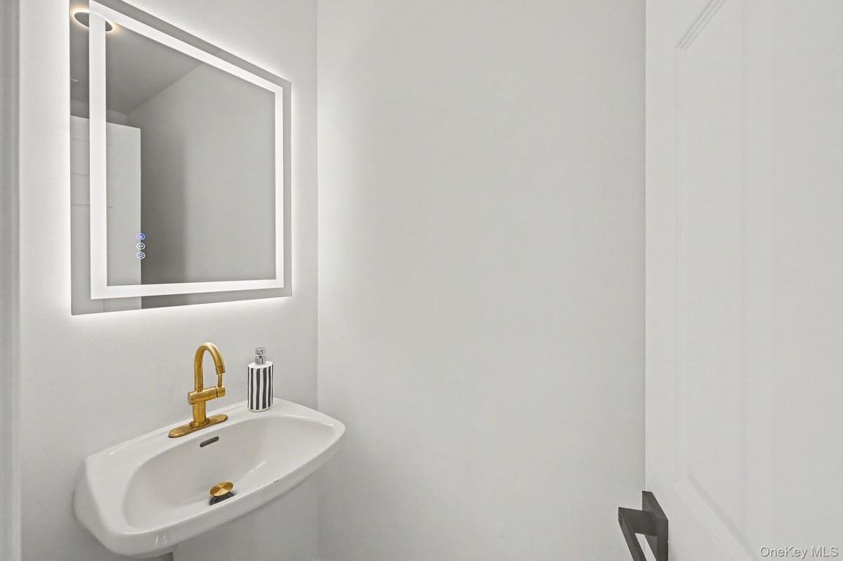 Half Bath next to entry stairs offthe kitchen