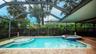 Full sized pool with spa and walk-in pool sunbath area.