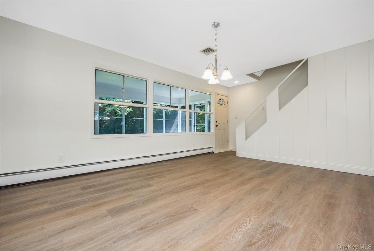 view of Dining area to covered patio/screen room and upper level staircase
