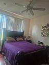 !st Floor Bedroom with wood flooring, recessed lighting, and a ceiling fan with integrated lighting, blinds and large window