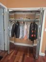 Additional mirrored closet in Master Bedroom with bi-fold doors, integrated upper shelving, and wood-finish flooring